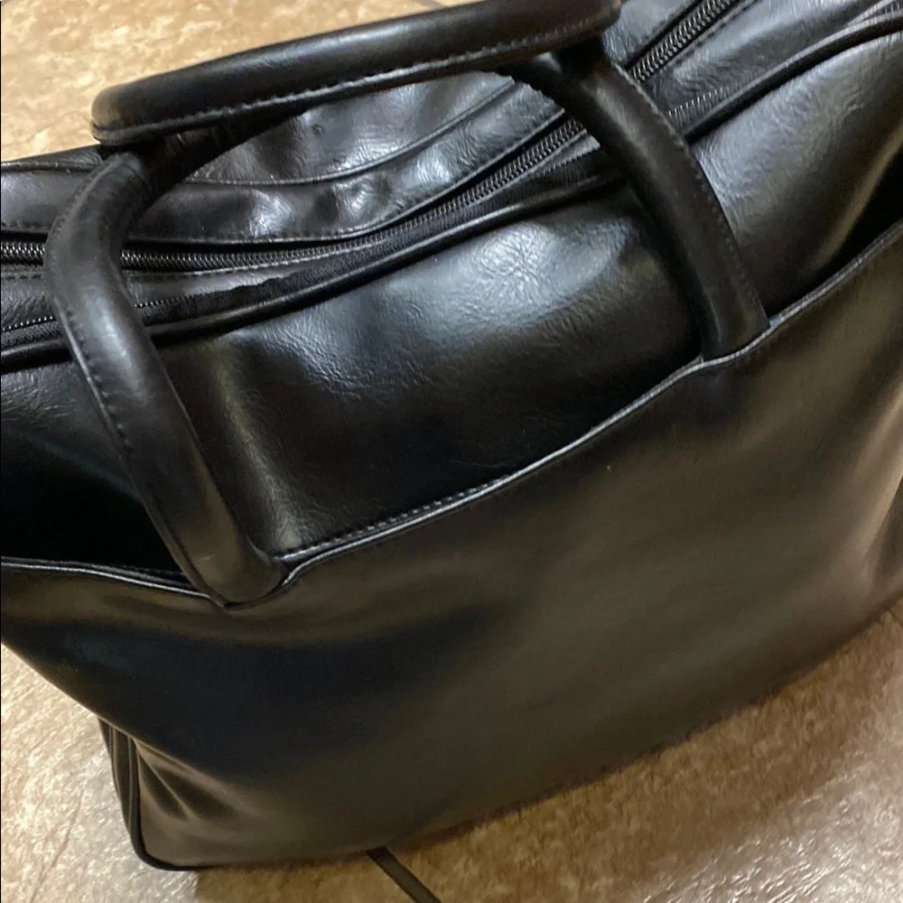 Black Duffel Bag with Structured Design and Smooth Vinyl Practical Utility